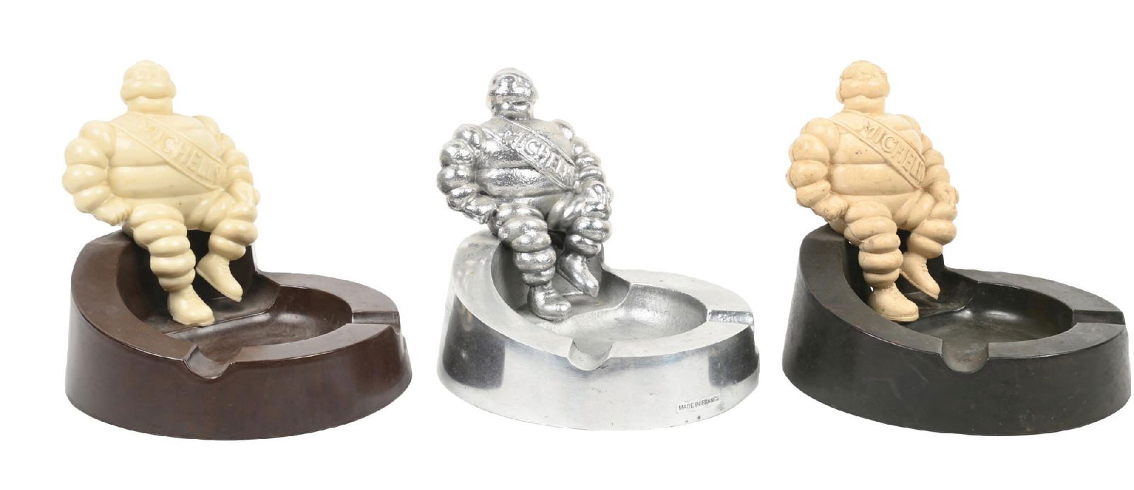COLLECTION OF 3: MICHELIN TIRES ADVERTISING ASHTRAYS.: Collection consists of: Three individual Michelin Tires advertising ashtrays, two of which are plastic and one is metal. CONDITION: Each are in original condition showing light use wear with no notabl