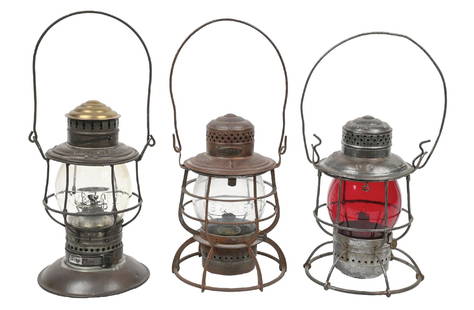 LOT OF 3 RAILROAD LANTERNS: (A) An Adams & Westlake 1895 pat. brass-top bell-bottom. &#8220;C. M. & St. P Ry.&#8221; nicely embossed on the lid reflector. The globe is a clear Corning-style Non-ex, embossed &#8220;C. M. & St. P