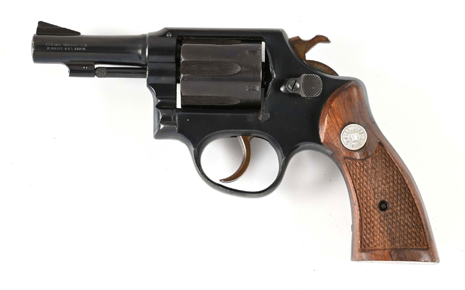 (M) TAURUS MODEL 80 DOUBLE ACTION REVOLVER.: This is an older model that has the serrated cylinder flutes with blue finish, case color hammer and trigger, fixed sights, and checkered walnut grips. CONDITION: Excellent. Retains nearly all the ori