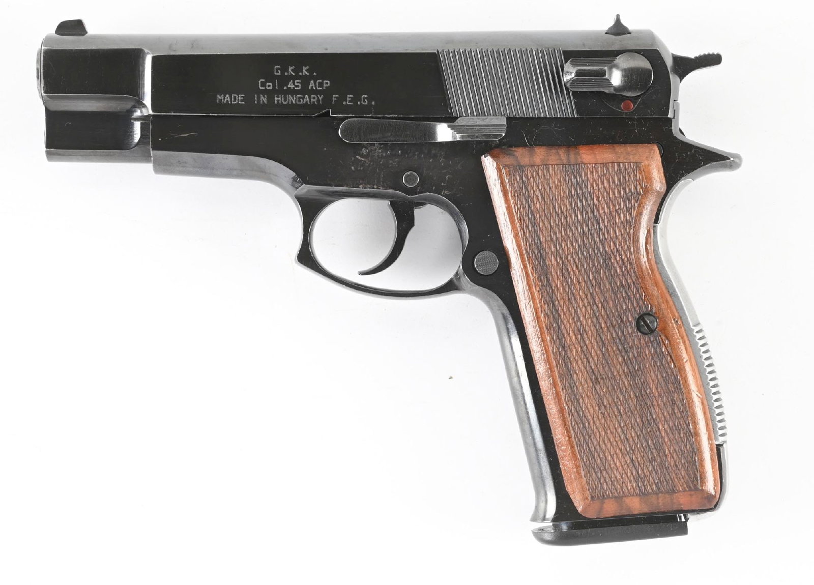 (M) FEG MODEL GKK 92C SEMI-AUTOMATIC PISTOL.: High polish blue finish, checkered walnut grips, and wind drift rear sight. CONDITION: Excellent. Retains 98% finish with some scattered handling marks. Bore is bright. Barrel Length: 4 - 1/4" Caliber