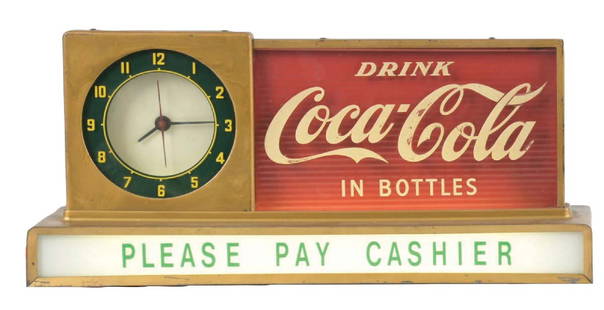 LIGHT-UP DRINK COCA-COLA IN BOTTLES PLEASE PAY CASHIER COUNTERTOP SIGN: Maker marked "Price Brothers". A nice example of this c. 1950s light-up counter top sign feature the iconic script logo along with a clock and "Please Pay Cashier" tagline. CONDITION: The "Cashier" si