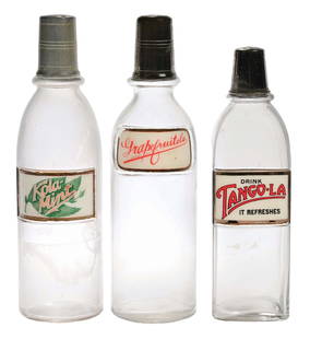 COLLECTION OF 3 LUG SYRUP BOTTLES TANGO-LA, GRAPFRUITOLA, & KOLA MINT: C. 1920. Collection of 3 label under glass soda syrup bottles. CONDITION: (A) Kola Mint, showing light chipping at the edges, no cracks or breaks, with original lid. (B) Grapefruitola showing small