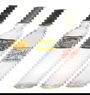 COLLECTION OF 3 LUG SODA SYRUP BOTTLES LEMON-LIFE, TRICKLE, & NUGRAPE: C. 1920. Collection of 3 label under glass soda syrup bottles. CONDITION: (A) Lemon Life showing light chipping and staining at the edges, no breaks or cracks, with original lid. (B) Nugrape showing
