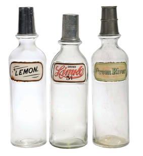 COLLECTION OF 3 SODA SYRUP LUG BOTTLES GREEN RIVER, LIMKO, & LEMON: C. 1920. Collection of 3 label under glass syrup soda bottles. CONDITION: (A) Lemon, showing light chipping and staining at the edges, no breaks or cracks, with original lid. (B) Limko, showing light