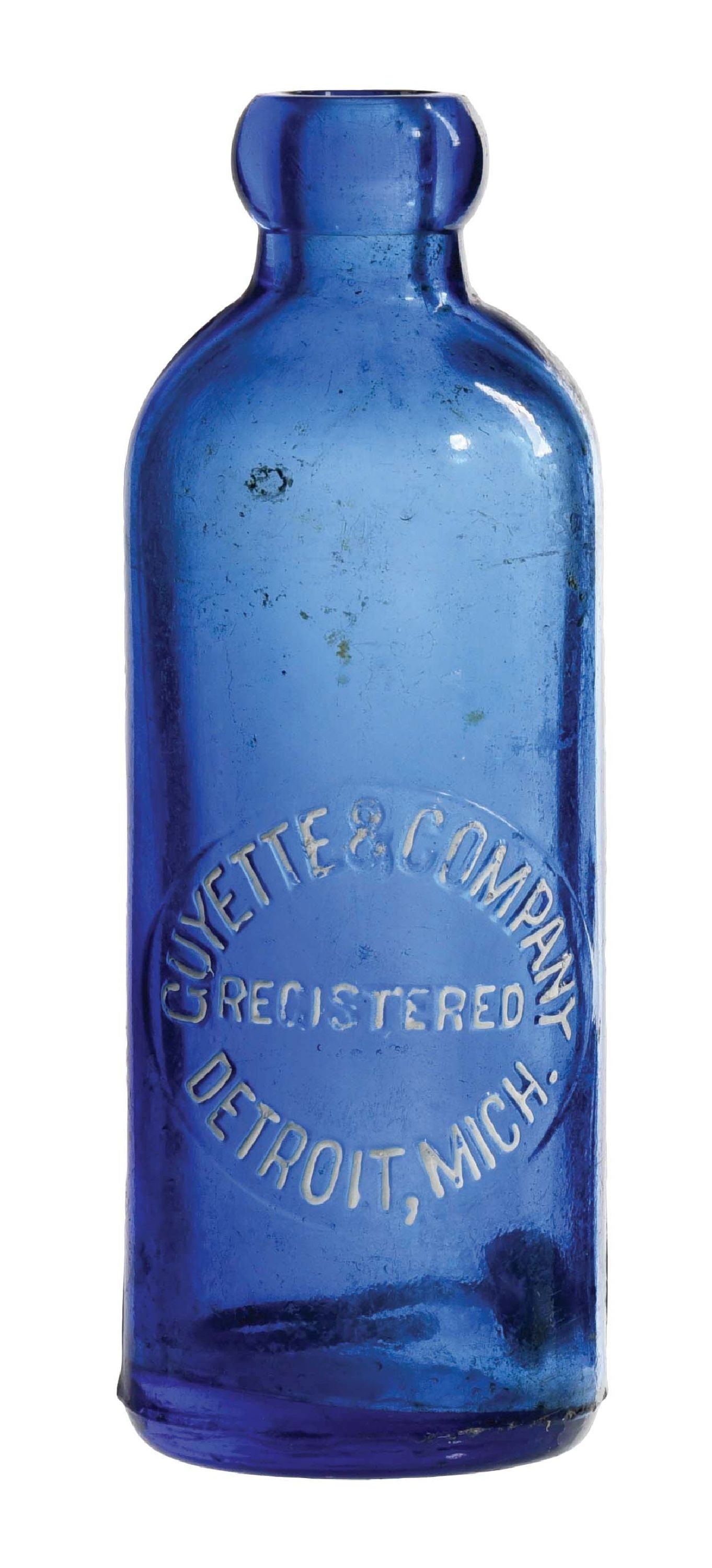 GUYETTE & COMPANY HUTCHINSON BOTTLE: Cobalt blue Hutchinson bottle featuring an embossed oval slug with "GUYETTE & COMPANY / REGISTERED / DETROIT, MICH.". The front oval slug embossing has been accented with white paint. Bottle has fleab