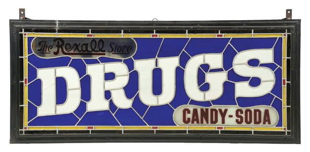 LARGE DRUGS CANDY-SODA "REXALL" LEADED GLASS SIGN: A stunning example of this double-sided leaded glass "Drugs, Candy, Soda" sign featuring The Rexall Store. The sign shows wonderful colored glass on both sides with a well-crafted original can. CONDIT