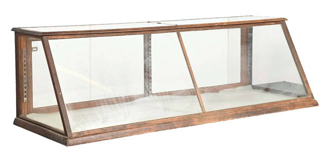 OAK SLANT FRONT COUNTRY STORE PASTRY CASE: C. 1910. CONDITION: It shows an all original finish to the oak framing with areas of scuffs, scrapes and scratches throughout. It shows all original glass, doors and hardware. This is not a standard s