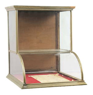 SMALL-SIZED CURVED GLASS COUNTRY STORE SHOWCASE W/ TOWER TOP IN GERMAN SILVER COVERING: C. 1910. CONDITION: It shows some repair to the showcase framing, and an area of brazing to the German silver covering in the lower left-hand front corner. The glass is all original, there is no inter