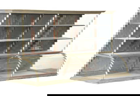 COUNTRY STORE CURVED GLASS HIGH-RISE SHOWCASE IN GERMAN SILVER: C. 1910. CONDITION: Showing areas of wear, some dents, scratches and scuffs to the German silver. All original glass with original back doors and hardware. This is not a standard shippable item and