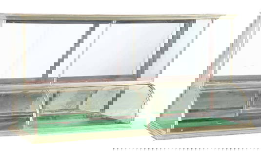 LARGE CURVED GLASS COUNTRY STORE SHOWCASE: C. 1910. CONDITION: German silver high-top curved glass showcase showing all original glass, original rear doors, with no added interior shelves. Some dings and scuffs to the German metal and areas of