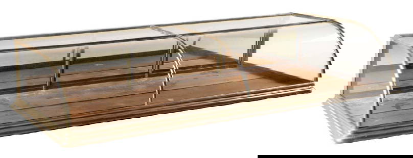 LARGE COUNTERTOP GLASS JEWELRY DISPLAY SHOWCASE: Curved glass front countertop display case. German silver over oak. CONDITION: Original glass and rear doors. This is not a standard shippable item and will require 3rd party shipping or pickup arrang