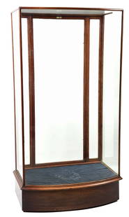 DISPLAY CASE: The back door has a double latch that opens for display pieces. This particular case is on wheels for easy movement. The interior label reads, "In Gold Showcase Makers 119 Old St. Phone 4069." CONDITI