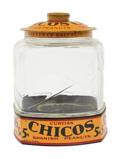 CURTISS CHICO'S SPANISH PEANUTS GLASS JAR: This display jar from Chico's Spanish Peanuts features a tin litho lid and base with great color and eye-appeal. CONDITION: The lid shows light fading to the color with a few small areas of paint loss