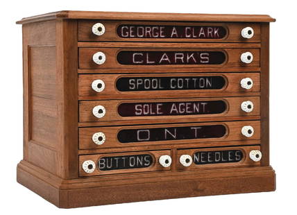 SALESMAN SAMPLE CLARKS SPOOL THREAD CABINET: C. 1930. CONDITION: Oak construction, with original reverse glass fronts and properly labeled for George A. Clark Clarks Spool Cotton. It has a complete set of drawers with drawer pulls and cabinet in