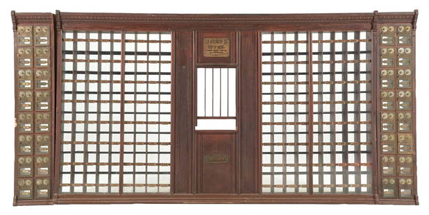 CORBAN CABINET LOCK CO. US POST OFFICE BOX DISPLAY: C. 1900. CONDITION: All wood construction in oak. It shows an original marked post office box interior, barred front and labeling for the U.S. Post Office. Two side panels are included, which contain