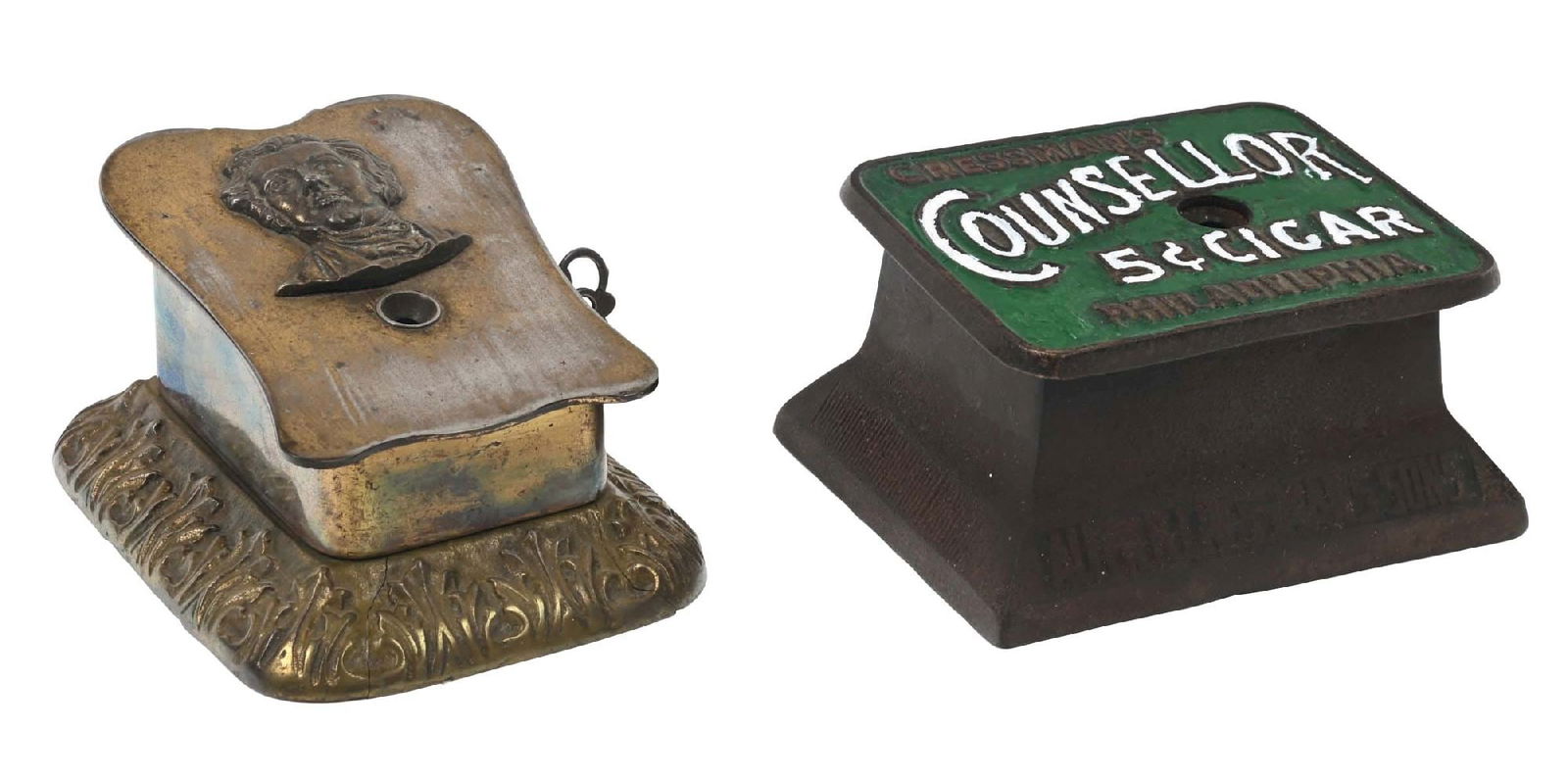 PAIR OF CLOCKWORK CIGAR CUTTERS: CONDITION: (A) A clockwork cigar cutter, showing two weld repairs to the base with an embossed man's head on the front and marked for the Jones Bros. Manufacturing Co. out of Cincinnati, Ohio. It is o