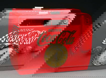 COCA-COLA COOLER RADIO W/ CLOCK: This c. 1950s cooler radio from Coca-Cola features the script logo nicely embossed on the front, with the clock face insert in the center. CONDITION: The body of the radio shows a few scuffs and speck