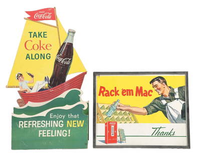 COLLECTION OF 2 COCA-COLA CARDBOARD SIGNS: A nice collection of two c. 1950s-1960s single-sided cardboard signs including the "Rack'em Mac" in its original metal frame, and the die-cut sail boat bottle display. The sailboat sign is three-dimen