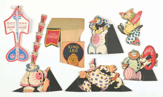 COLLECTION OF 8 COKE ADVERTISING CARDBOARDS: A miscellaneous selection of die-cut cardboard Coca-Cola items from various eras. CONDITION: All show light wear and damage. Condition: (8.0). Dimensions: Largest: 11 - 1/4" x 7".