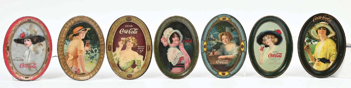 COLLECTION OF 6 COCA-COLA TIP TRAYS: A nice collection of six C. 1905-1915 tip trays from Coca-Cola featuring the iconic script logo with beautiful women graphics. CONDITION: All the trays show light wear in the field and minor paint