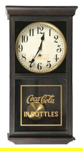 COCA-COLA GILBERT CLOCK: This c. 1930 Gilbert clock features the Coca-Cola logo in gold on the glass bottom, as well as another logo shows on the clock face. This clock comes with its original pendulum and winding key. CONDIT