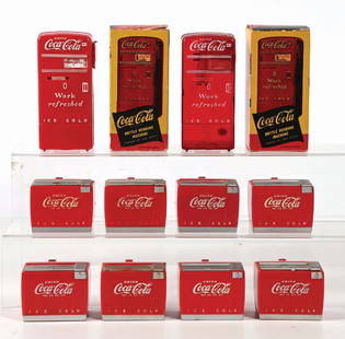 COLLECTION OF 12 COCA-COLA TOY VENDING MACHINES & MINI COOLER MUSIC BOXES: A nice collection of twelve Coca-Cola toys, including two toy banks, and ten miniature cooler music boxes. CONDITION: The two banks remain clean with light wear to the white lettering, and both retain