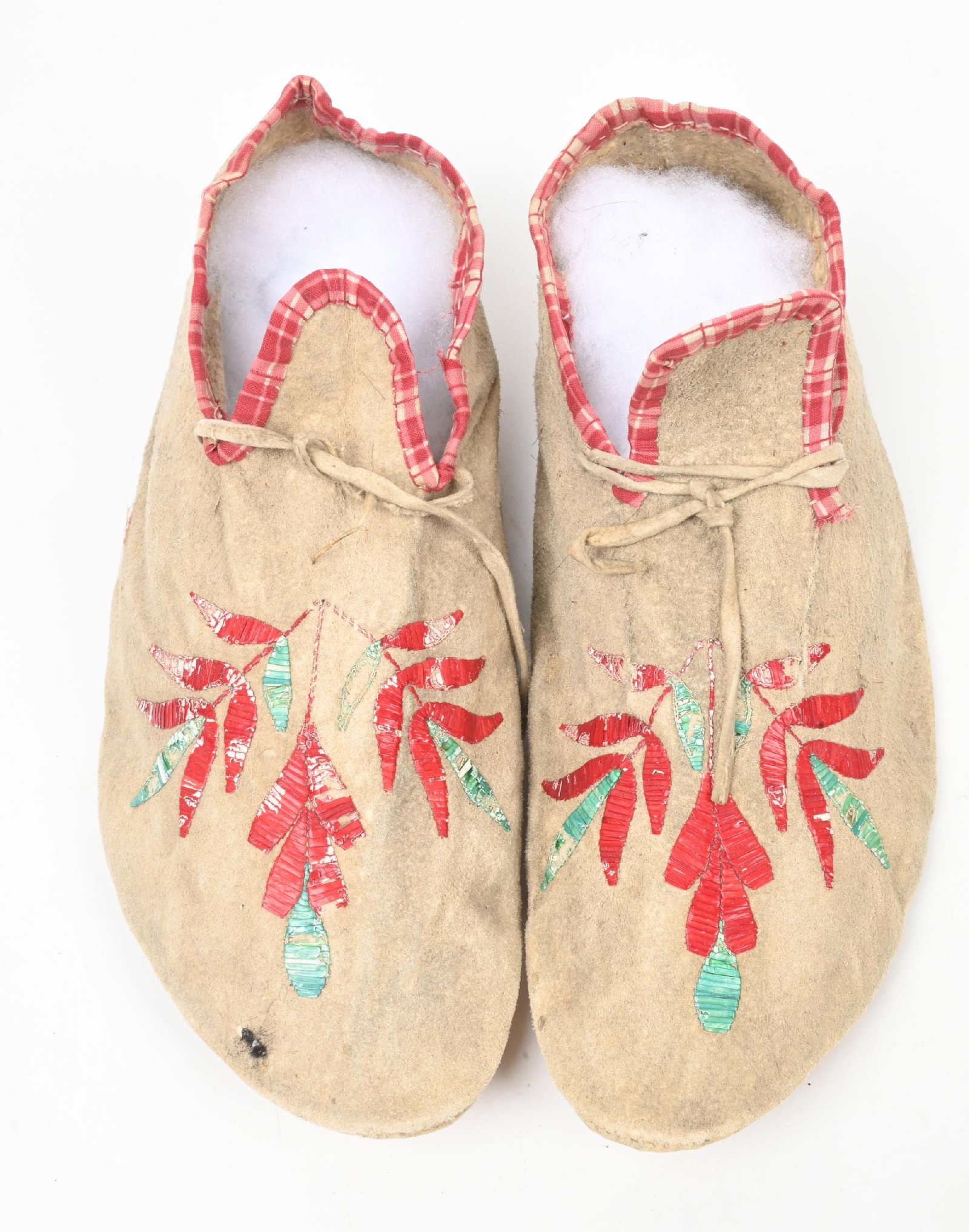 QUILLED MOCCASINS: Circa 1900 floral pattern moccasins finished with dyed porcupine quills. Circa 1900. CONDITION: Very good with some light bug damage to quill. Dimensions: 10 3/4" L.