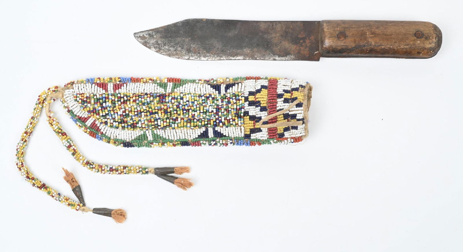 MULTI-COLORED BEADED KNIFE SHEATH: Lakota knife case finished in salt and pepper beadwork. Circa 1890s. 8" in length. CONDITION: Very good. Dimensions: 8" L