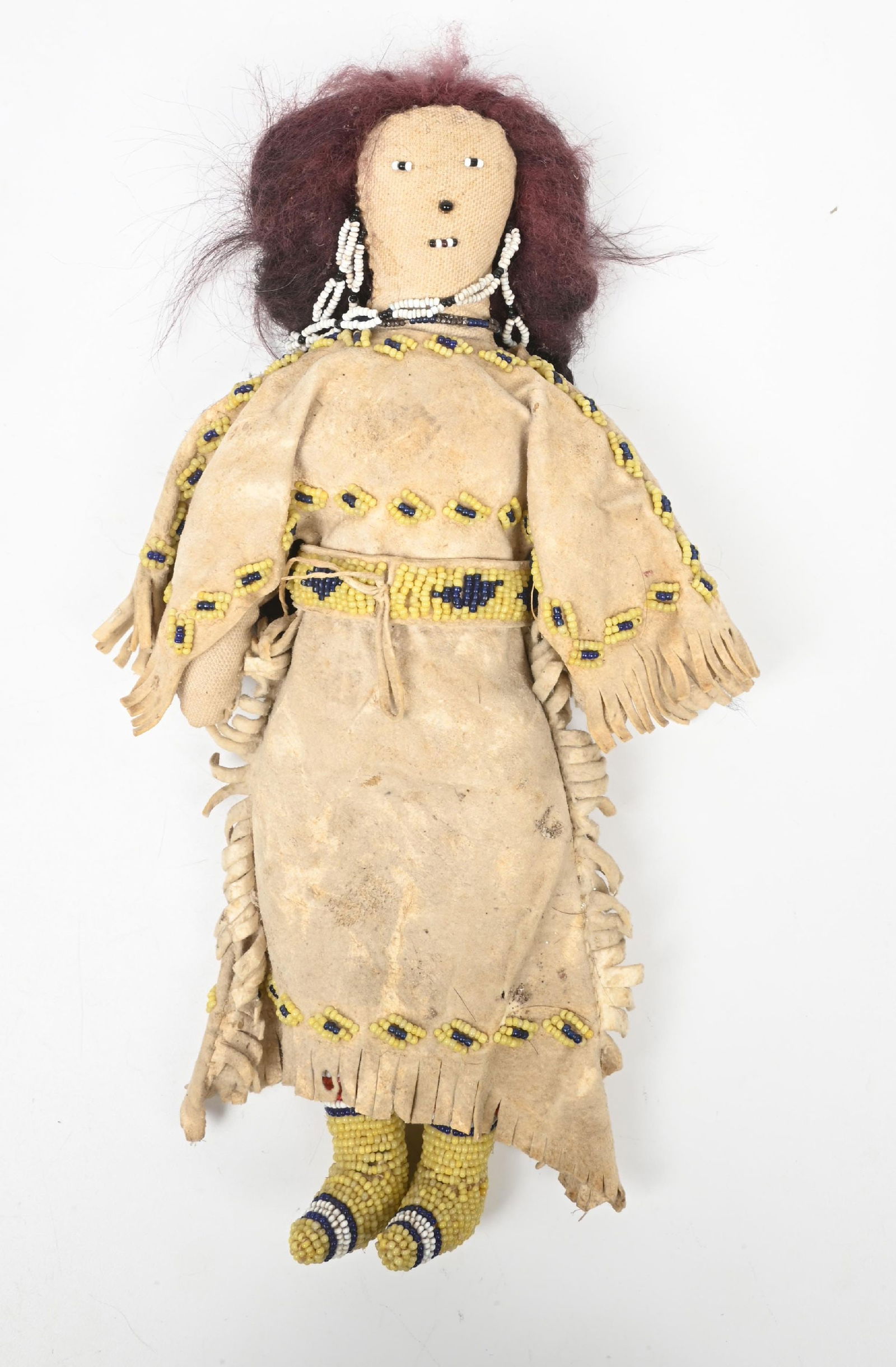 PLAINS BEADED DOLL: Constructed of Indian tanned buckskin, horse hair, and beaded moccasins. 6" W x 12" L. CONDITION: Very good. Dimensions: 6" x 12"