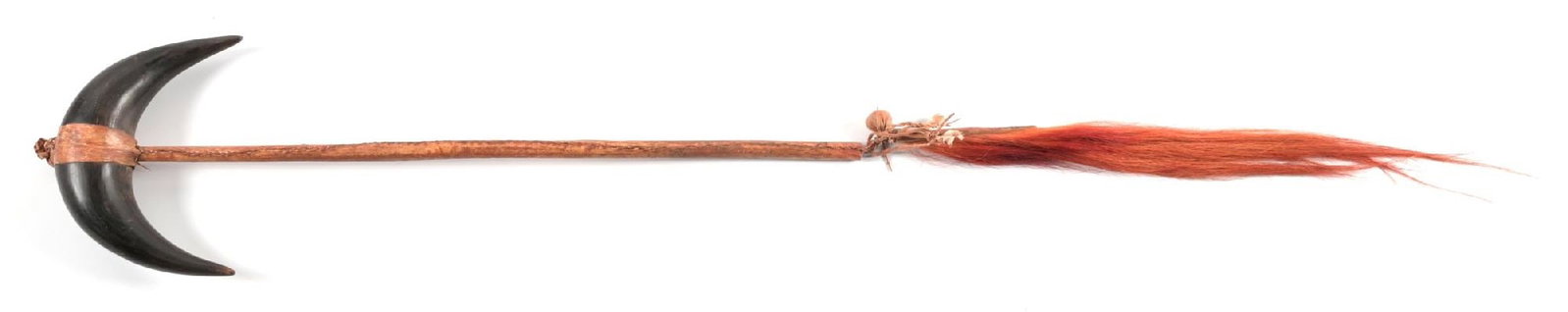 BUFFALO HORN CEREMONIAL CLUB: Rawhide wrapped handle with traces of red paint or pigment. Red dyed horsehair drop. 32" length. CONDITION: Very good. Dimensions: 32" L.
