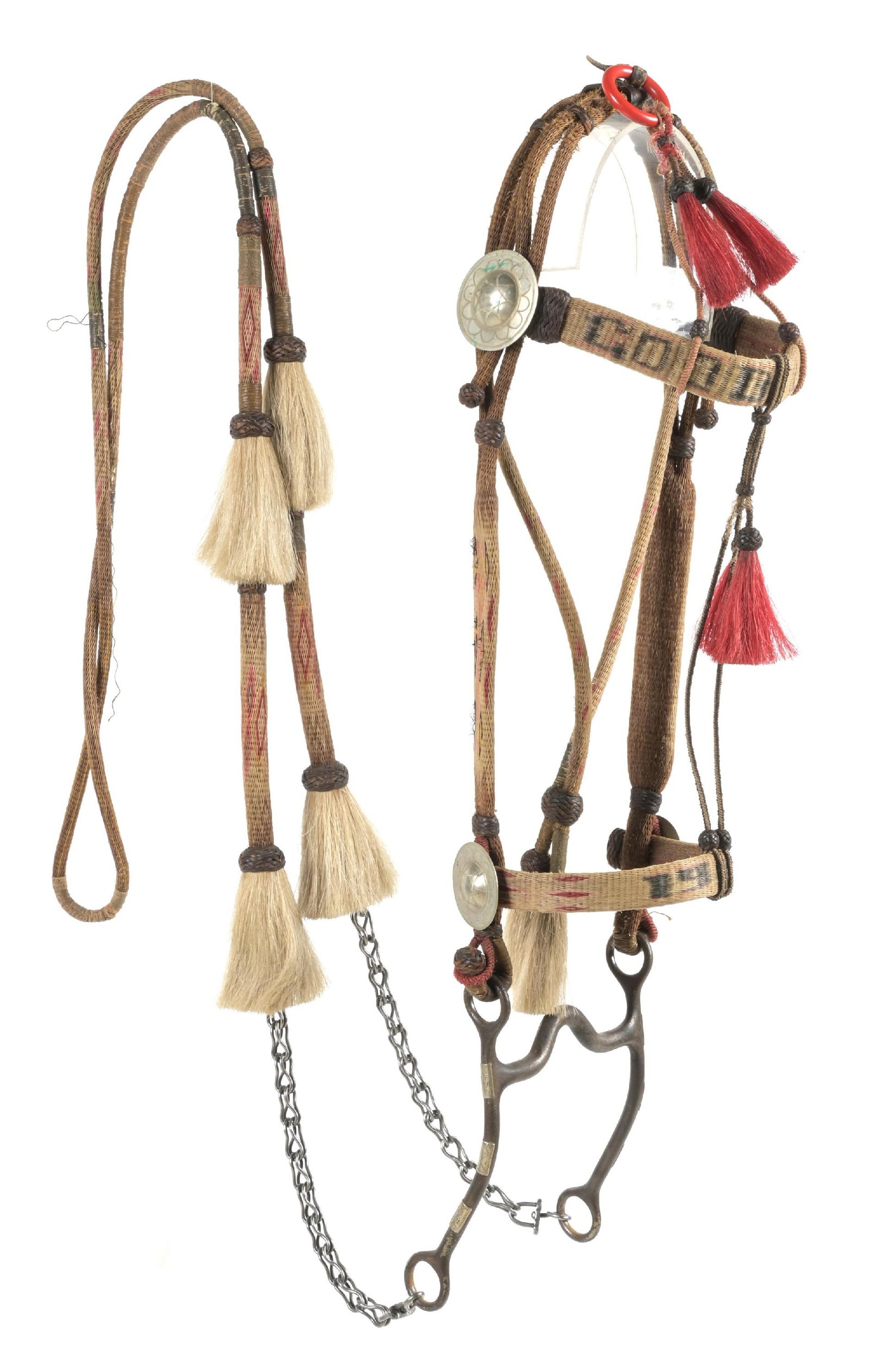 PRISON MADE TAN AND RED HORSEHAIR BRIDLE: Deer Lodge prison made hitched horsehair bridle with attached curb bit with small silver overlay panels. Brow band reads "GOOD LUCK". Circa 1910-1920. CONDITION: Very good with some light fading. Dime