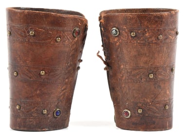 BROWN STUDDED LEATHER CUFFS.
