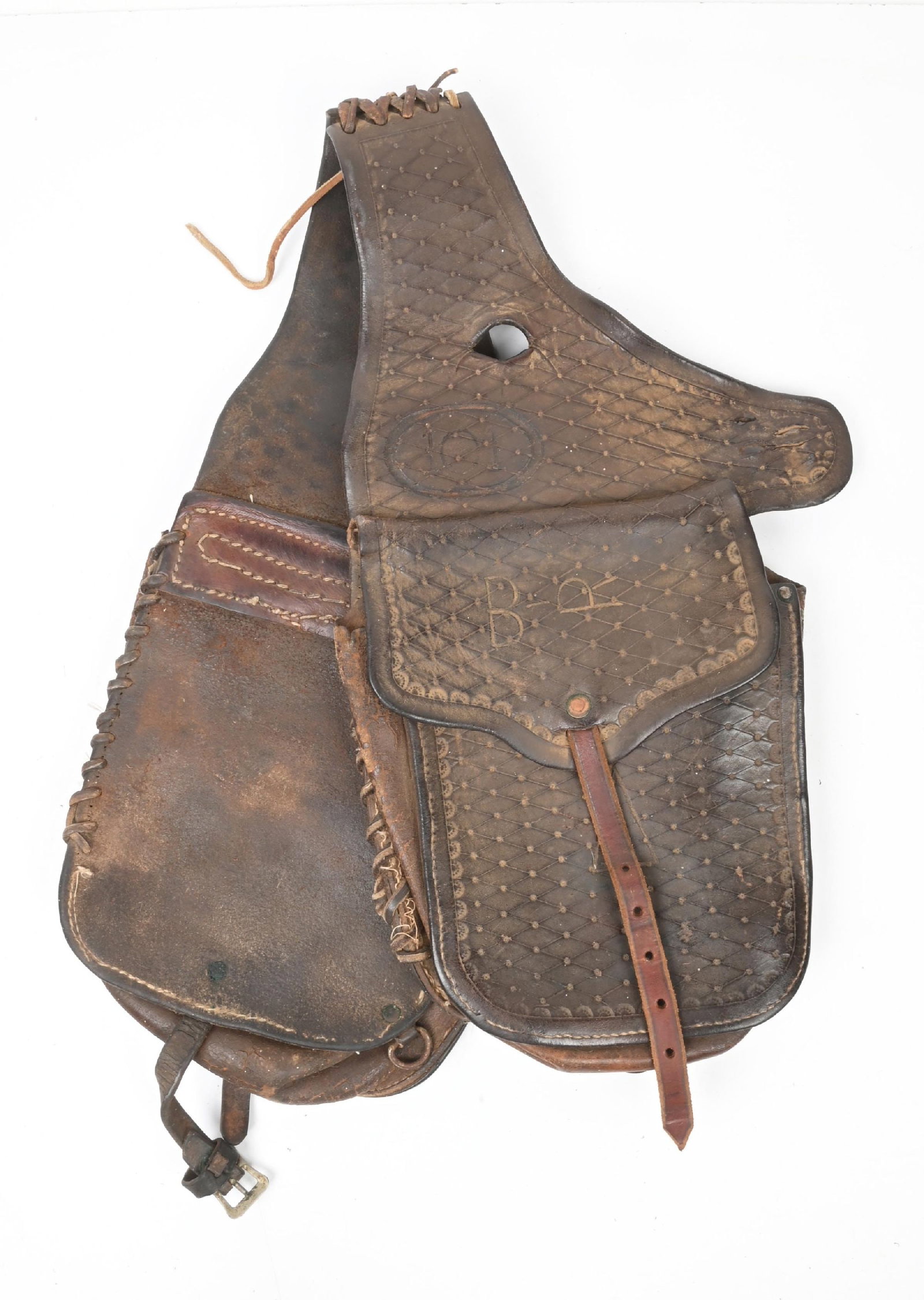 DOUBLE SIDED LEATHER SADDLE BAGS MARKED B-R: Tooled leather pommel or saddle bags. Branded "101" for possible Wild West show ownership or use. Each 18 1/2" long x 9" wide. CONDITION: Good, with heavy period wear. Dimensions: 18 1/2" x 9".