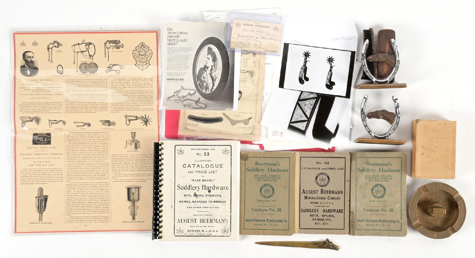 LOT OF SADDLE HARDDWARE CATALOGS AND WESTERN ITEMS: Mixed lot of August Buermann original and reprint catalogs, horseshoe bookends, and related items. Great library items for the saddle, spur, and bit collector and researcher. CONDITON: Very good. Dime