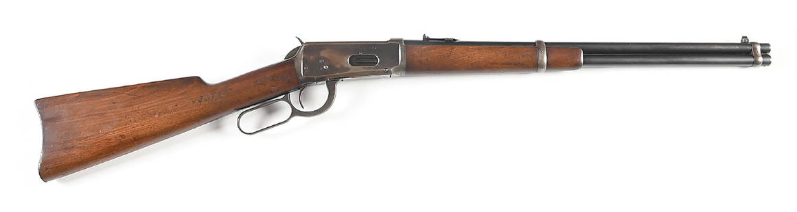 (C) WINCHESTER MODEL 1894 .38-55 SADDLE RING CARBINE.: Manufactured in 1907. Gumwood stocks, other features as standard including post front sight, folding leaf express rear sight, carbine butt plate, saddle ring, and blue finish. CONDITION: Fine. The bar