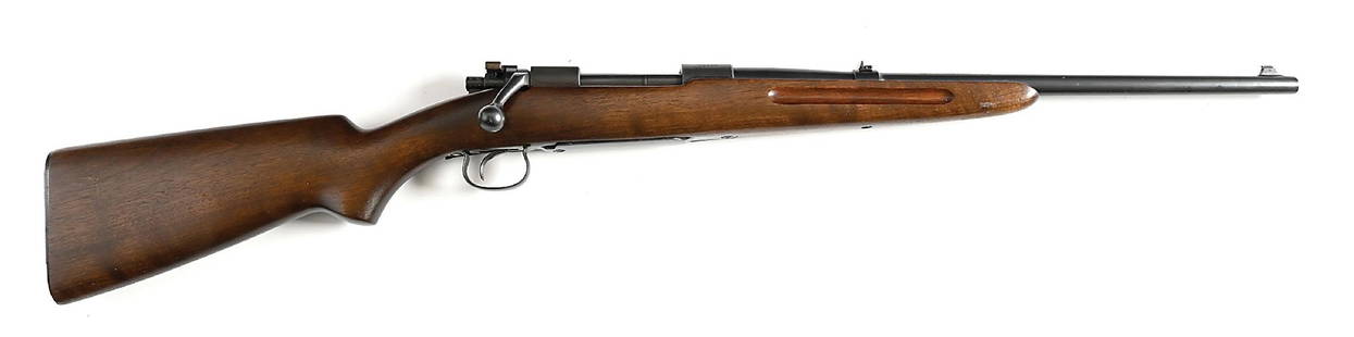 (C) WINCHESTER MODEL 54 BOLT ACTION CARBINE IN .30-30.: Frame dates to 1929. The .30 WCF chambering is listed in 1930, lasting only through 1931. The walnut carbine stock features a plain pistol grip, finger groves on forearm, a metal butt plate, and no sw