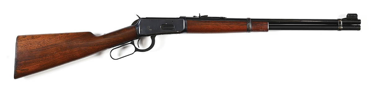 (C) PRE-WAR WINCHESTER MODEL 94 LEVER ACTION EASTERN CARBINE IN .25-35.: Manufactured in 1938. This carbine features the hooded ramp front sight that became standard in 1932. Serrated steel butt plate. Rear sight is a semi-buckhorn sporting type. Walnut stocks with matchin