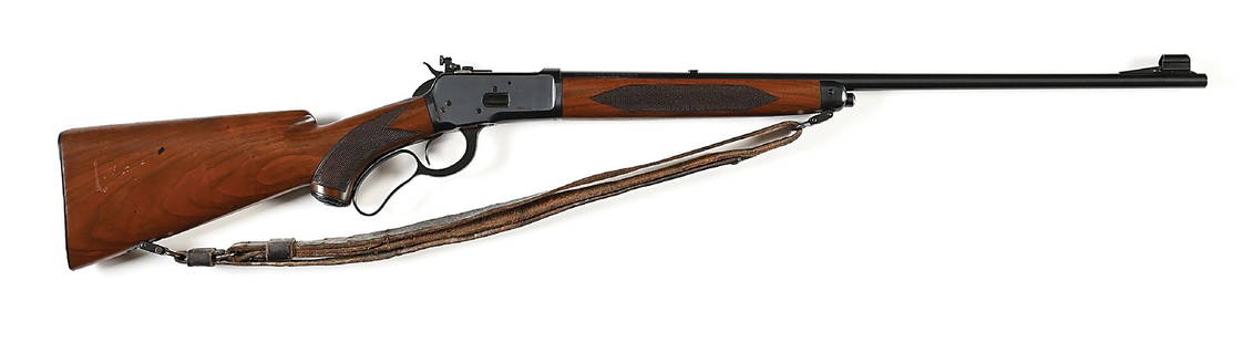 (C) HIGHLY DESIRABLE DELUXE WINCHESTER MODEL 65 LEVER ACTION RIFLE IN .218 BEE.: Manufactured in 1939. This deluxe features a walnut stock with checkered pistol grip, a Winchester cap, checkered steel buttplate, and matching forearm. Features blue finish, round barrel, hooded ramp