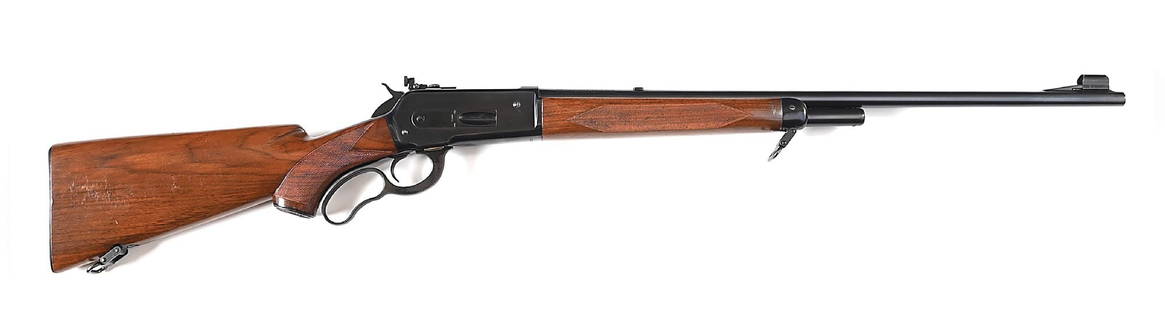 (C) FINE DELUXE WINCHESTER MODEL 71 LEVER ACTION RIFLE.: Wartime 1942 manufacture. Finished in full blue. Tapered Winchester proof steel barrel with ramped and hooded bead top blade front sight. Desirable bolt peep rear sight, the barrel dovetail filled in