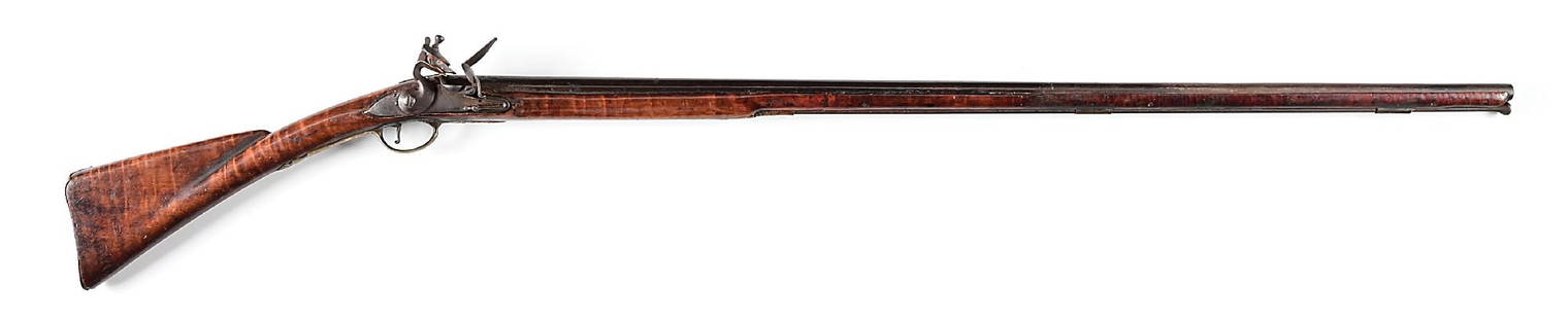 (A) TIGER MAPLE STOCKED AMERICAN FLINTLOCK FOWLER.: Tapered round American barrel with crude rings at breech. Unmarked convex lockplate. Brass furniture including flat plain full sideplate and trigger guard terminating in acanthus leaf designs at both