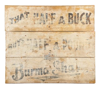 BURMASHAVE THAT HALF A BUCK BUYS HALF A POUND PAINTED WOOD HIGHWAY SIGN.