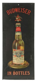 BUDWEISER IN BOTTLES TIN OVER CARDBOARD SIGN W/ BOTTLE GRAPHIC.