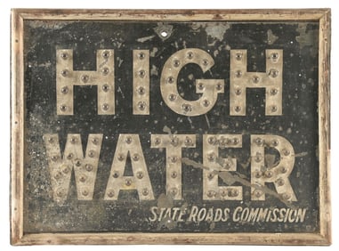 HIGH WATER STATE ROAD COMMISSION TIN SIGN WITH GLASS REFLECTORS AND WOOD FRAME.