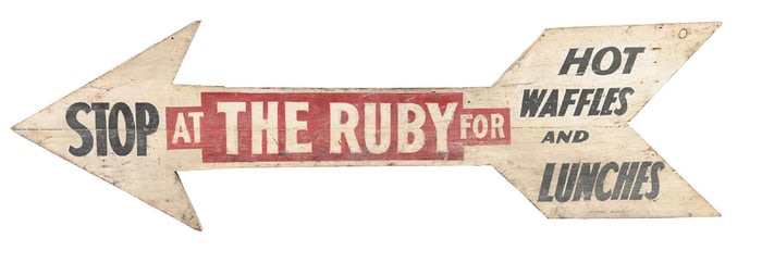 STOP AT THE RUBY HAND PAINTED WOODEN ARROW SIGN.