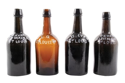 COLLECTION OF 4 AMBER GLASS D.H. EVANS BREWERIANA BOTTLES