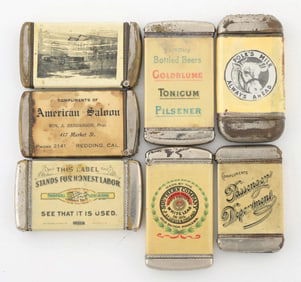 COLLECTION OF 7 CELLULOID-WRAPPED MATCH SAFES