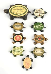 COLLECTION OF 9 CAST IRON TURTLES WITH ADVERTISING BACKS