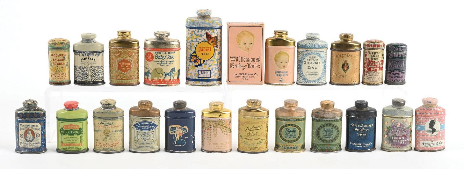 LARGE LOT OF MINIATURE TALCUM POWDER TINS: A wonderful instant collection of these miniature talcum powder tins, featuring wonderful color and graphics. CONDITION: The tins show moderate wear, spots of color loss, and scraping. They display ni