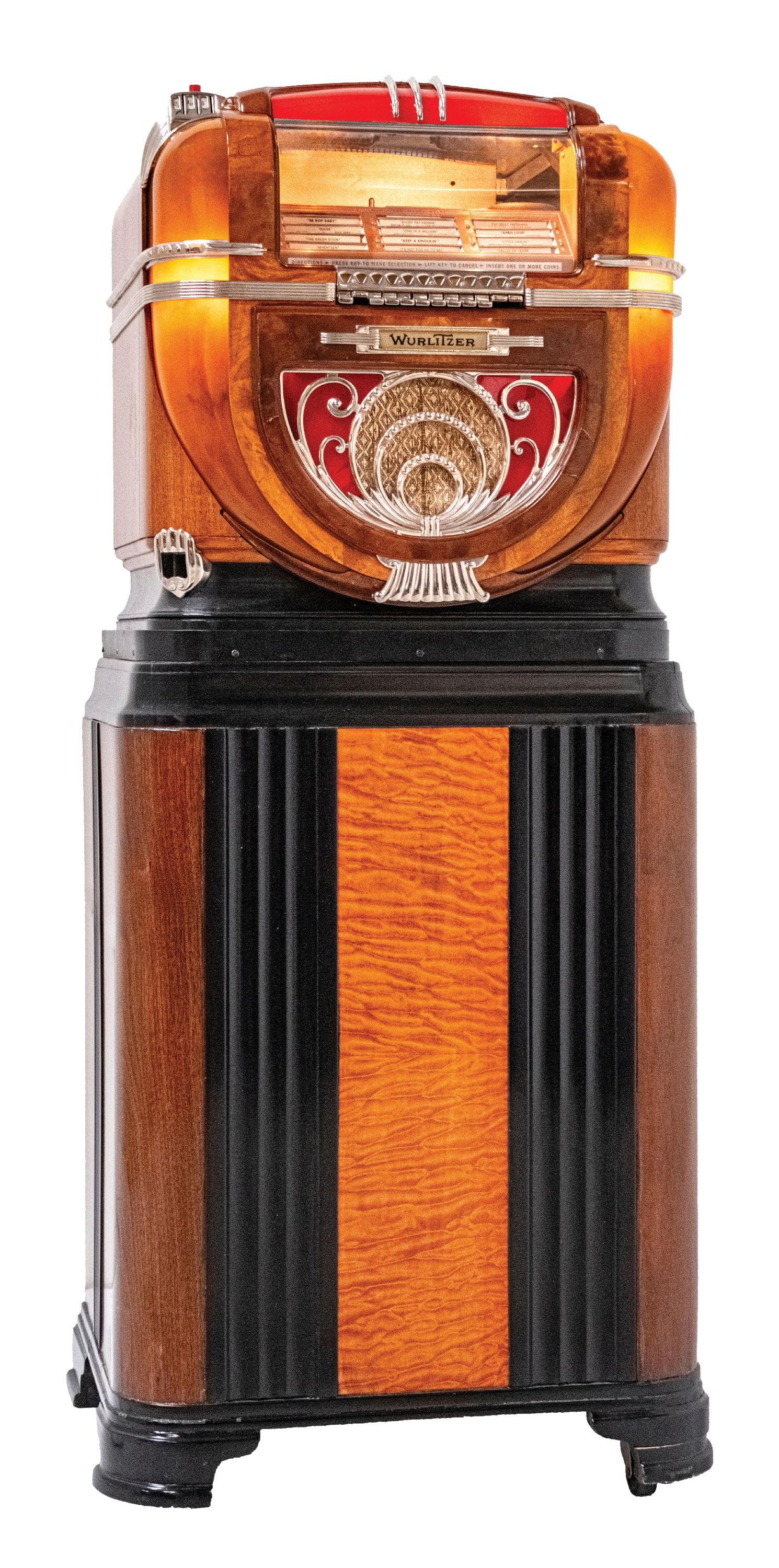 WURLITZER JUKEBOX MODEL 71 WITH STAND: C. 1941. CONDITION: All original jukebox with correct plastics, front castings, and interior. Showing an older restoration, inside and out. The stand is an original 710. Box shows light wear and oxida