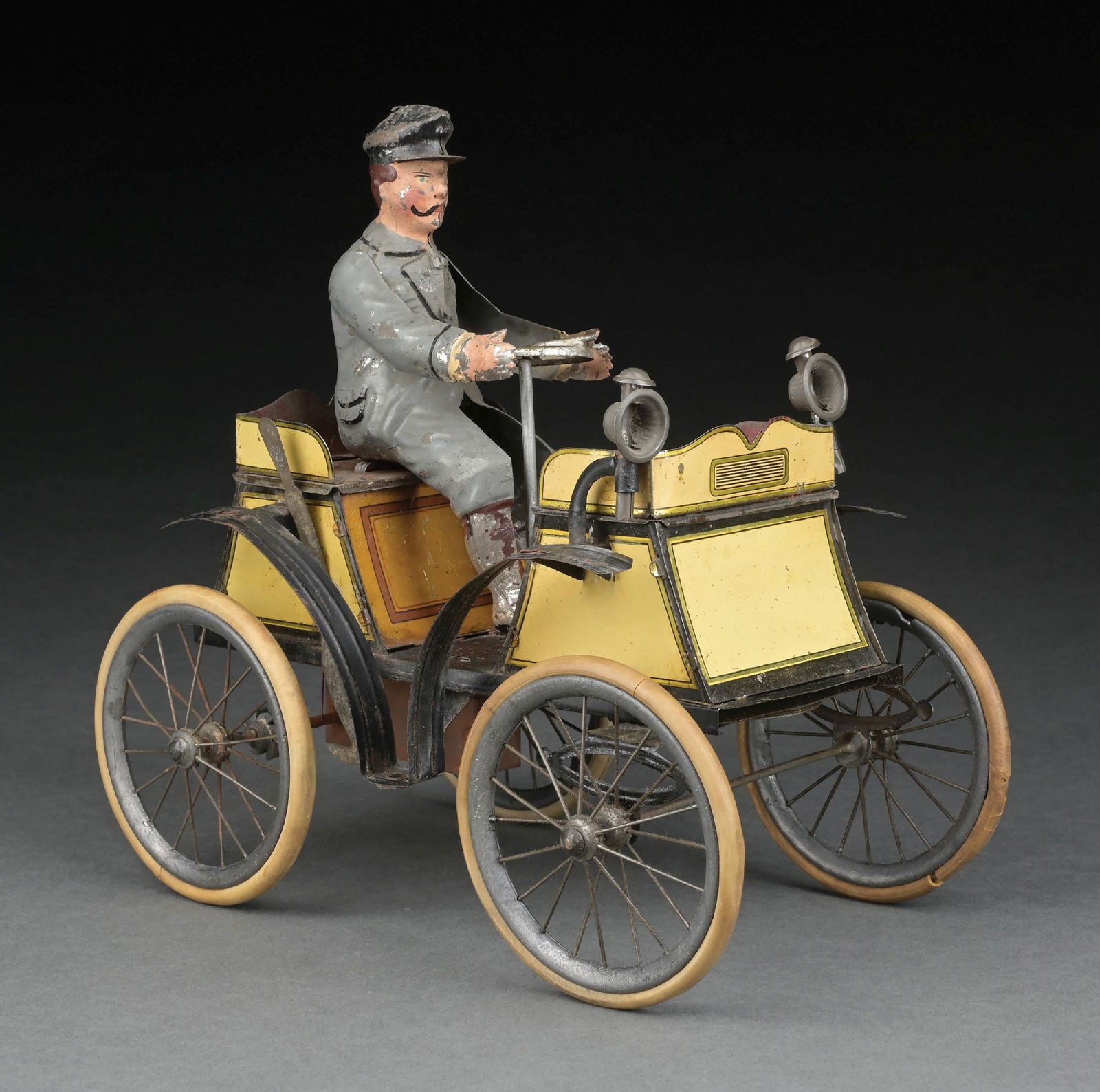 GERMAN GUNTHERMANN TIN LITHO CLOCKWORK VIS-A-VIS AUTOMOBILE: Rare car with unusual yellow litho with gold highlights and trim. CONDITION: Original hand-painted figure. Looks to have original headlamps and tires. Some oxidation around mechanism and rear axles. S